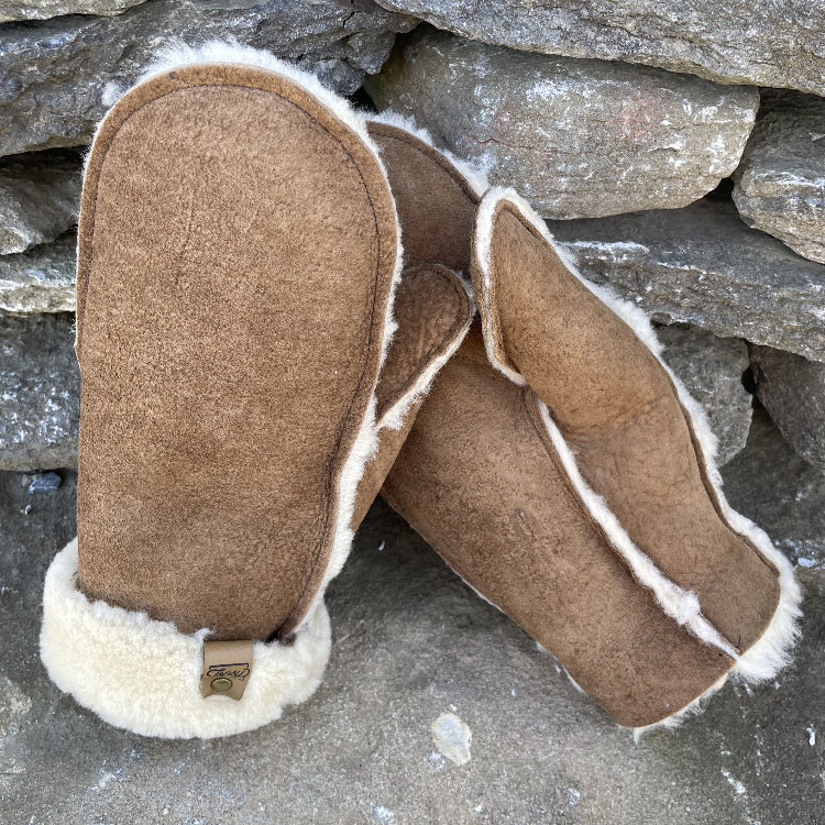 Topsy Farms' Canadian sheepskin mittens on a rock wall