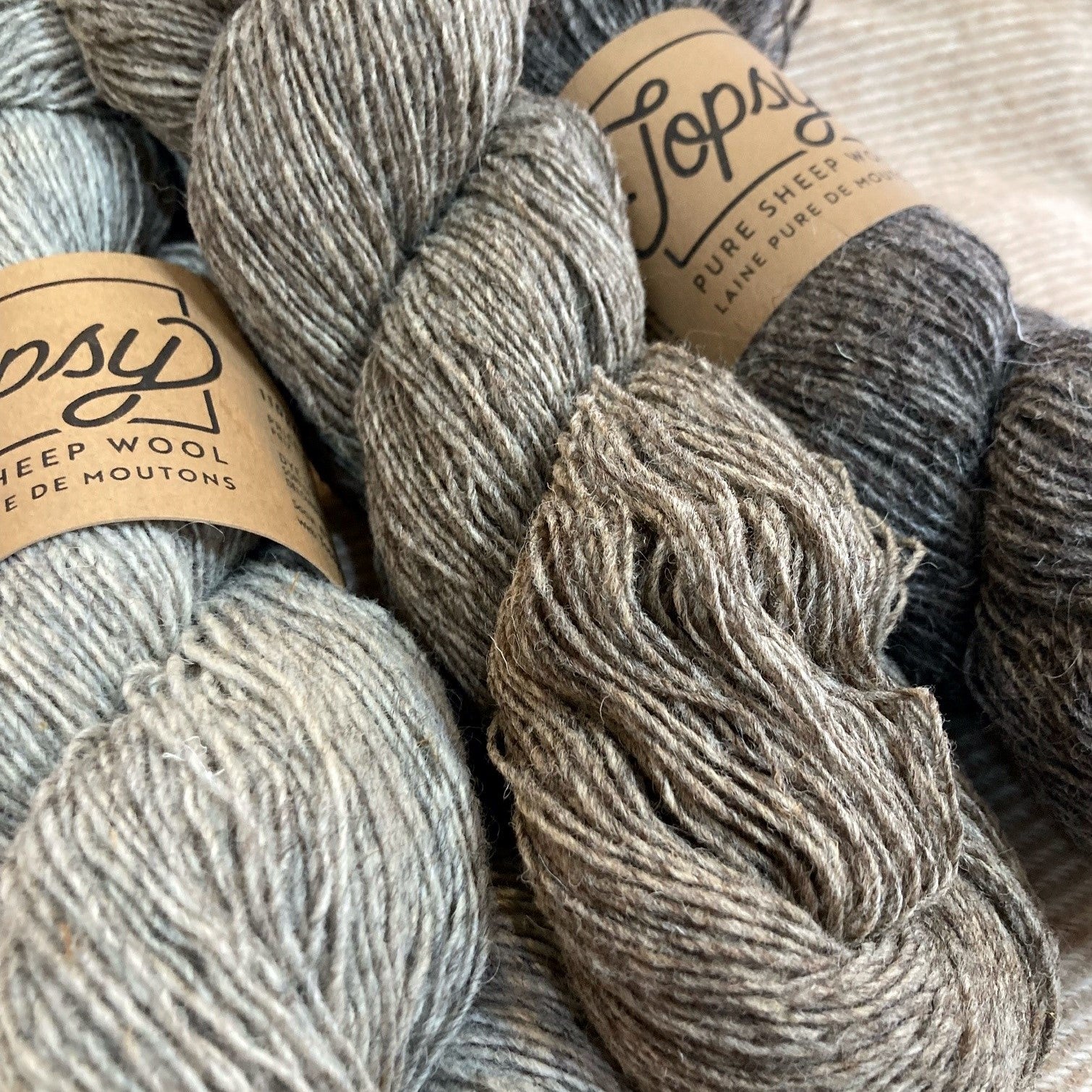 3 skeins of Topsy Farms' grey yarn