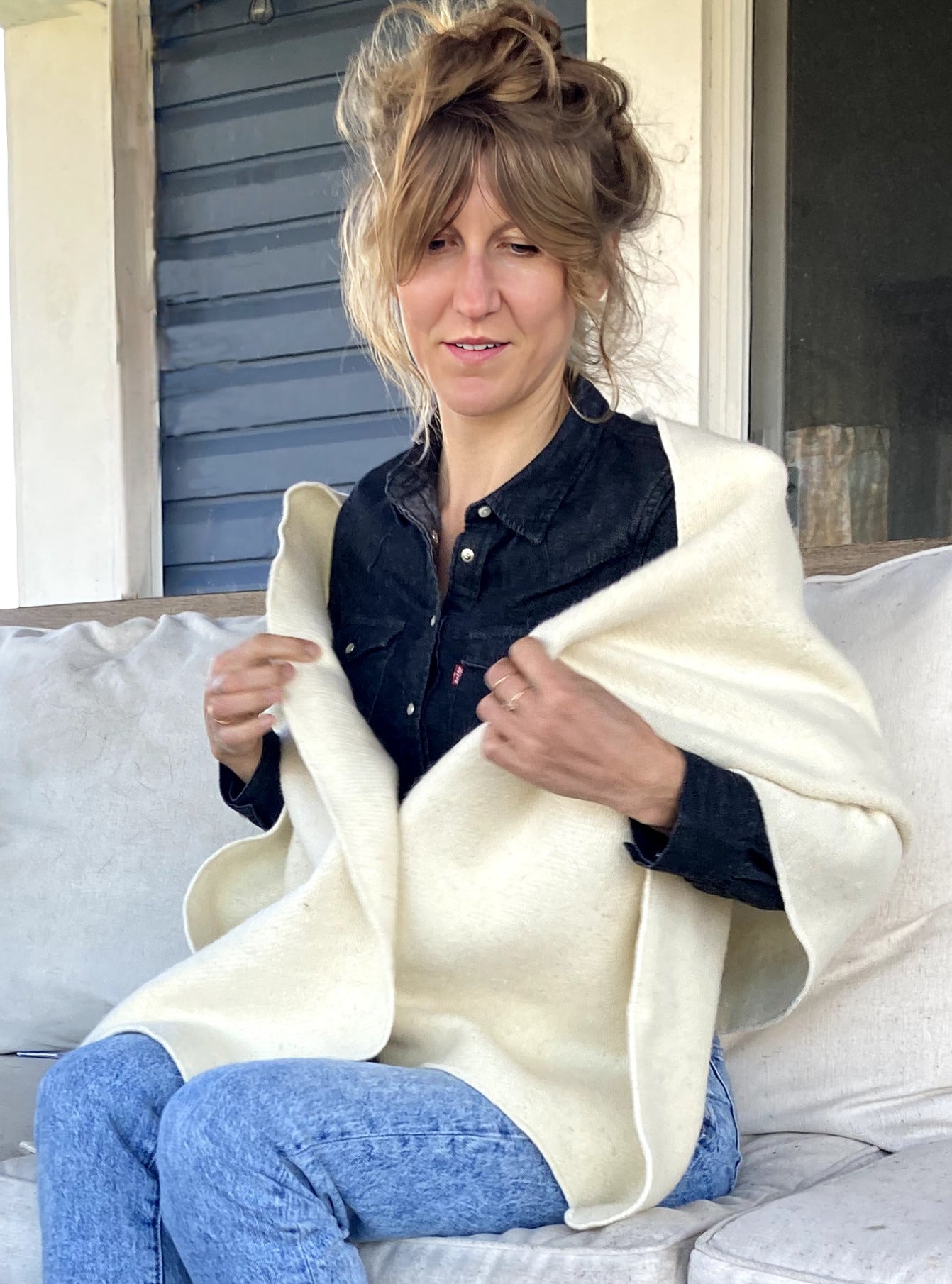 Blonde woman on a deck in a Topsy Farms' wool patio wrap