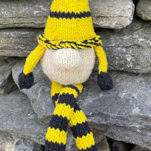 Topsy Farms' handmade wool shelf elf on stone wall