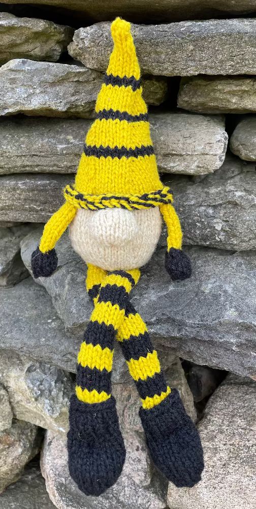 Topsy Farms' handmade wool shelf elf on stone wall