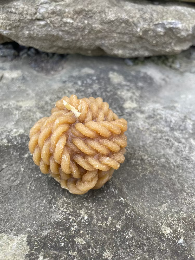 Topsy Farms' handmade beeswax candle in the shape of knotted rope