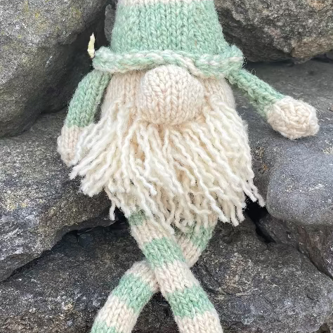 Topsy Farms' handmade wool shelf elf on stone wall