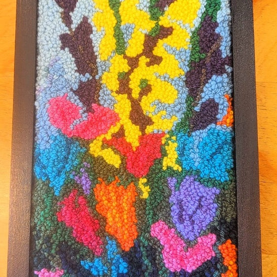 Topsy Farms' handmade wool wall hanging of colourful flowers