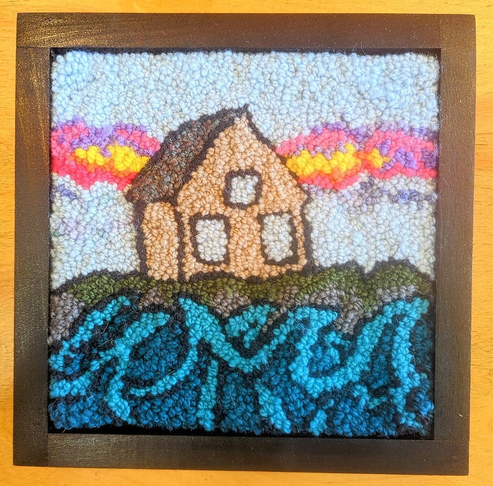 Topsy Farms' handmade wool wall hanging of a house by a lake