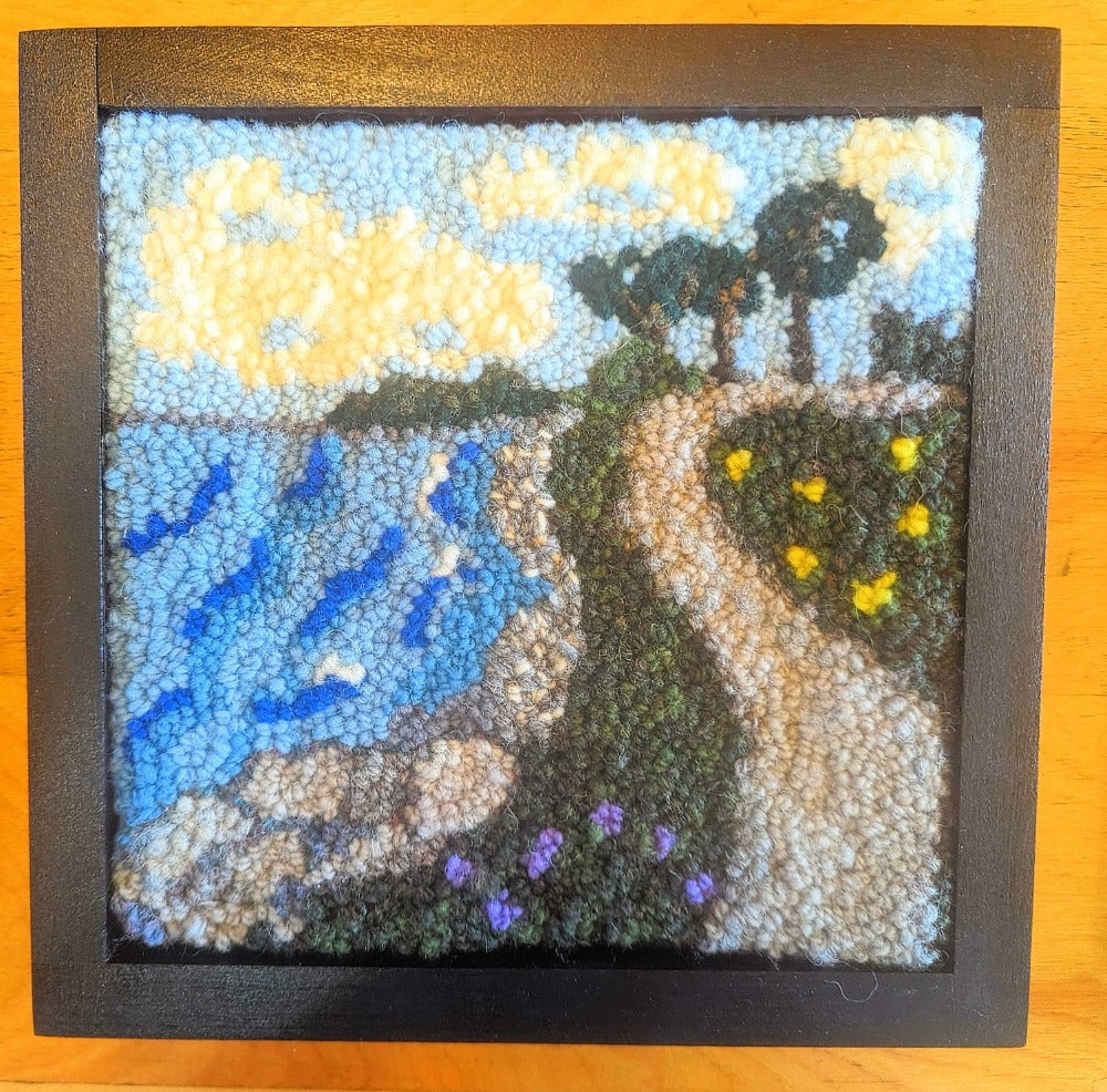 Topsy Farms' handmade wool wall hanging of a road by a lake