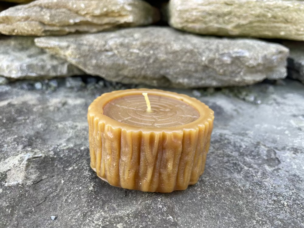 Topsy Farms' handmade beeswax candle in the shape of a log