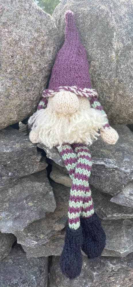 Topsy Farms' handmade wool shelf elf on stone wall