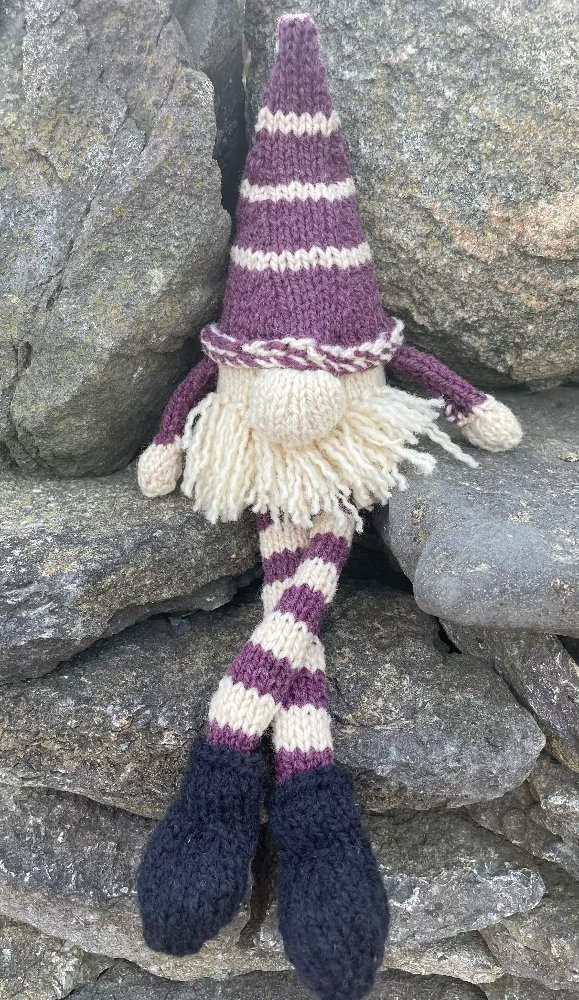 Topsy Farms' handmade wool shelf elf on stone wall