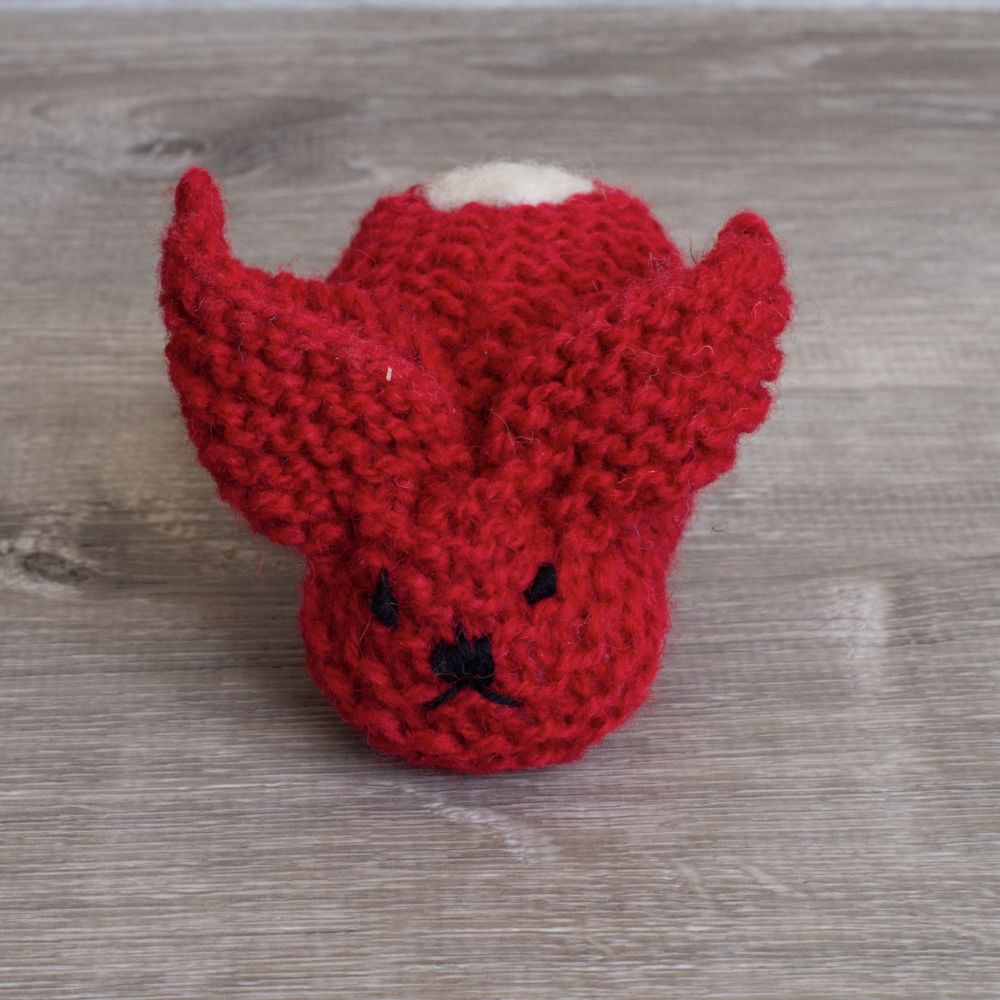 Red knitted wool bunny with white tail, by Topsy Farms