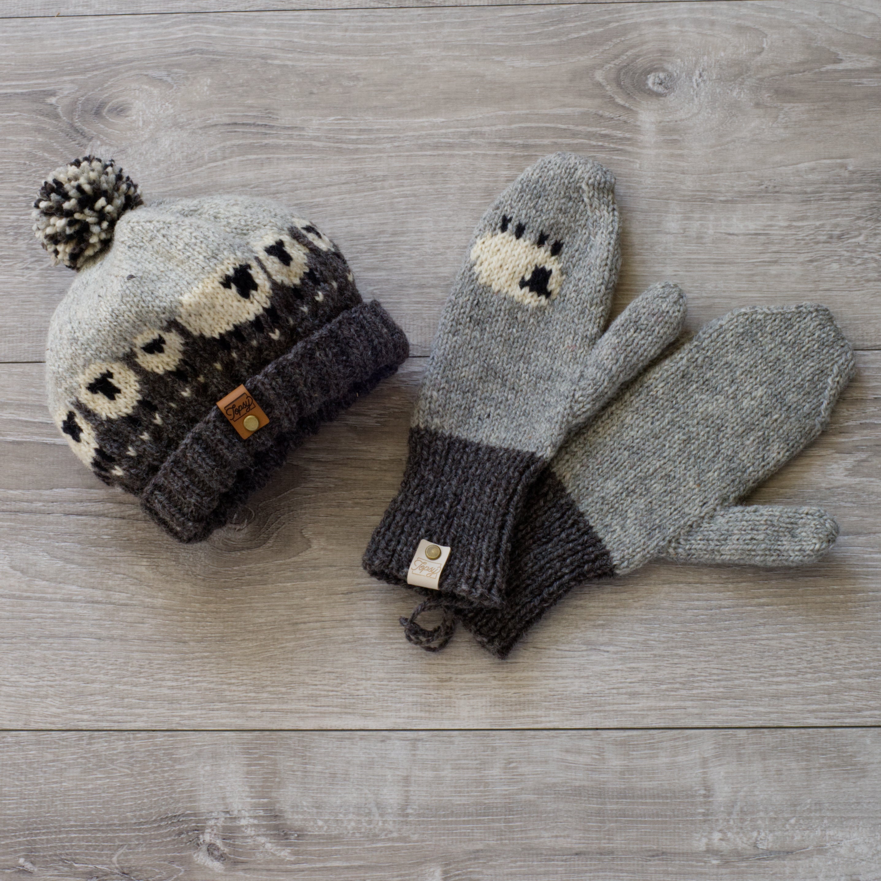 Topsy Farms grey, white and black wool pompom hat with sheet, with matching mitts