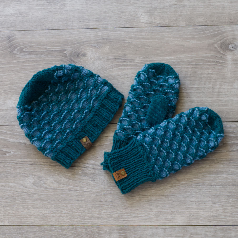 Knitted blue and green toque and mittens in a honeycomb pattern