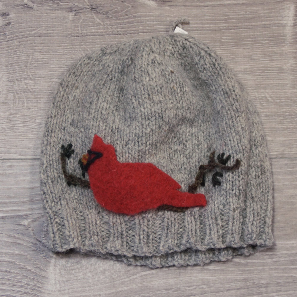 Light grey knitted toque with felted cardinal attached. Made with Topsy Farms' wool