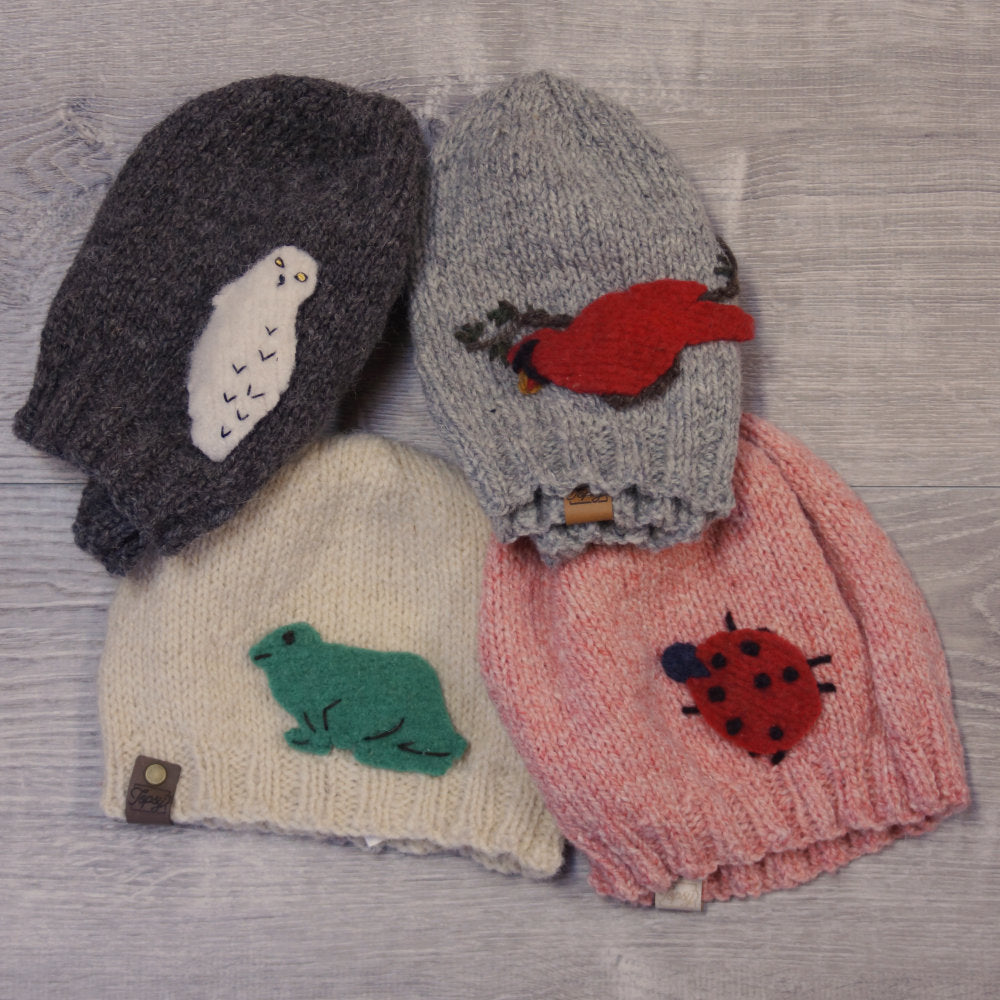 Set of 4 knitted toques, with felted applique animals attached. Made with Topsy Farms' wool.