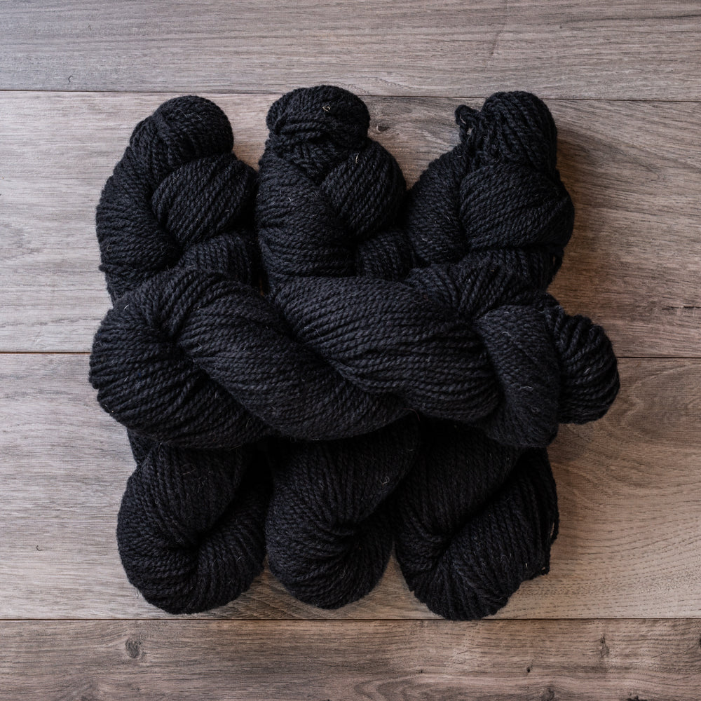 Black skeins of yarn.