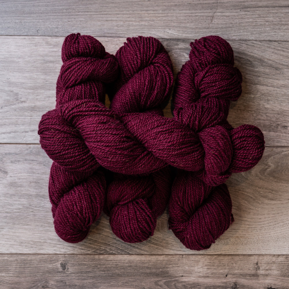 Burgundy skeins of yarn.