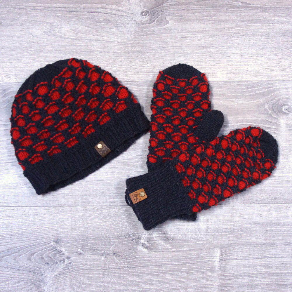 Knitted black and red toque and mittens in a honeycomb pattern